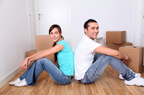 Loading furniture into a van on a North London residential street